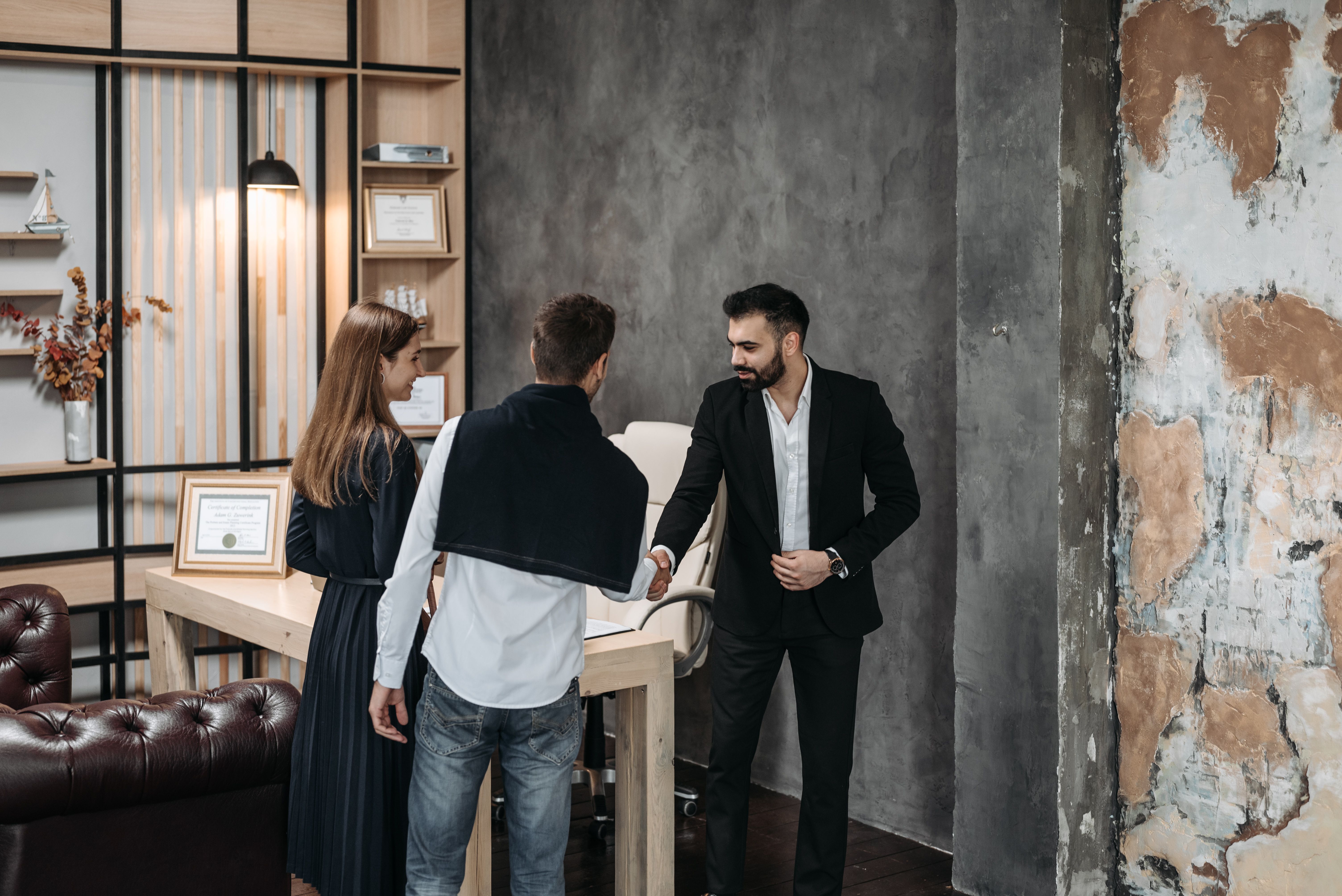 Professionals meeting in an elegant modern office and greeting one another with a handshake.